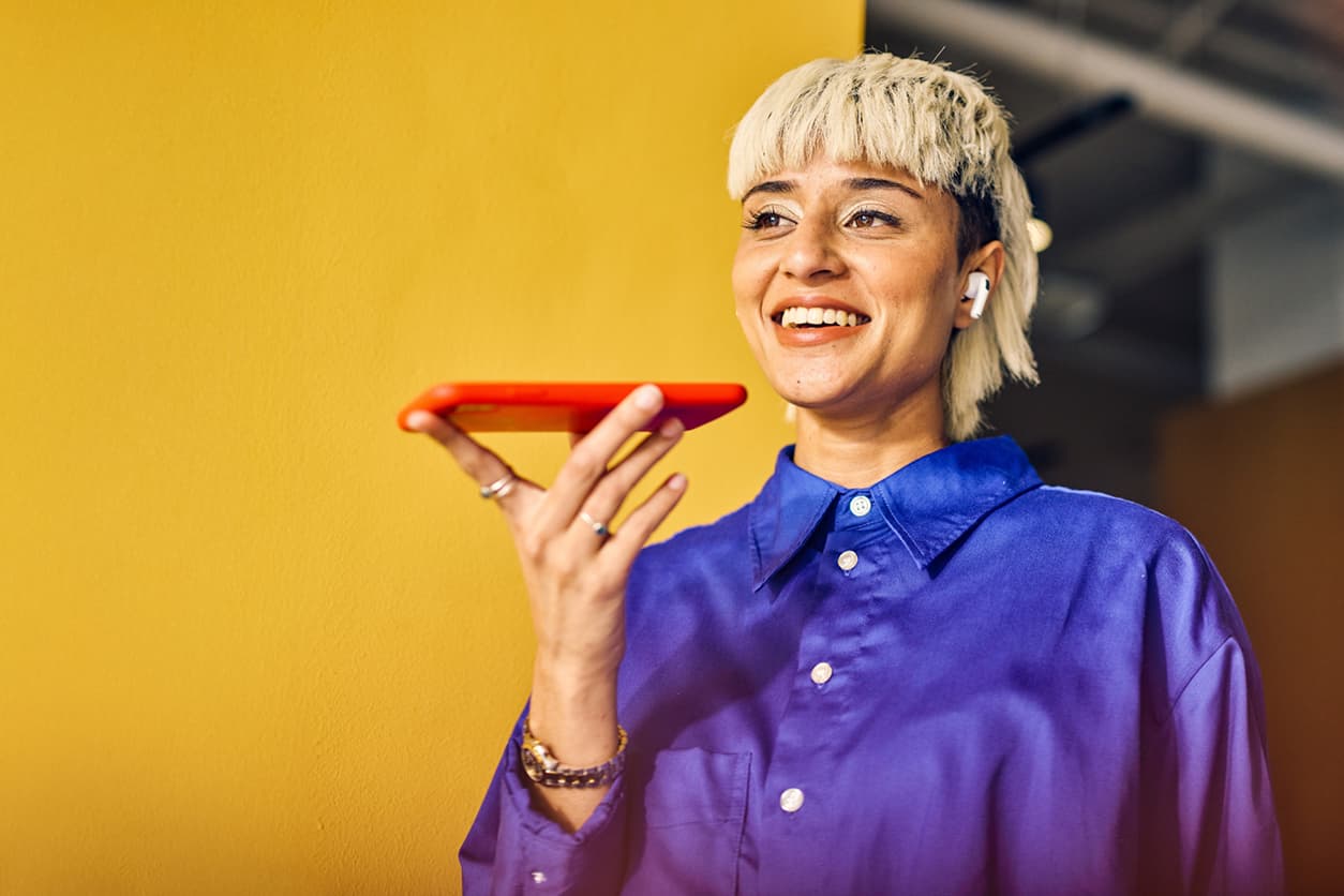 A young woman talking into her phone while smiling