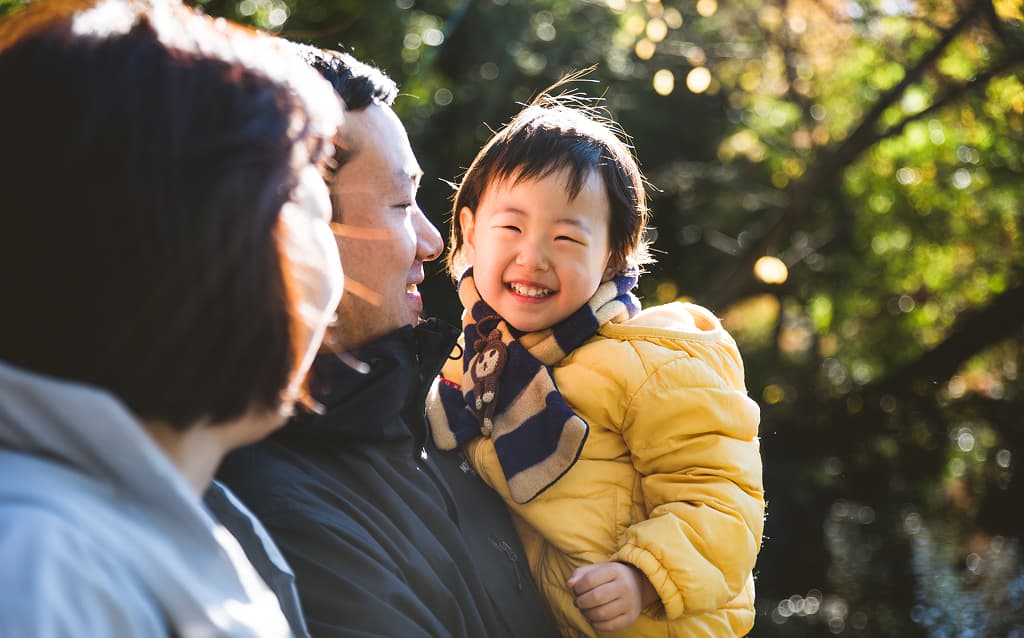 Happy and playful Japanese family in a park in Tokyo
