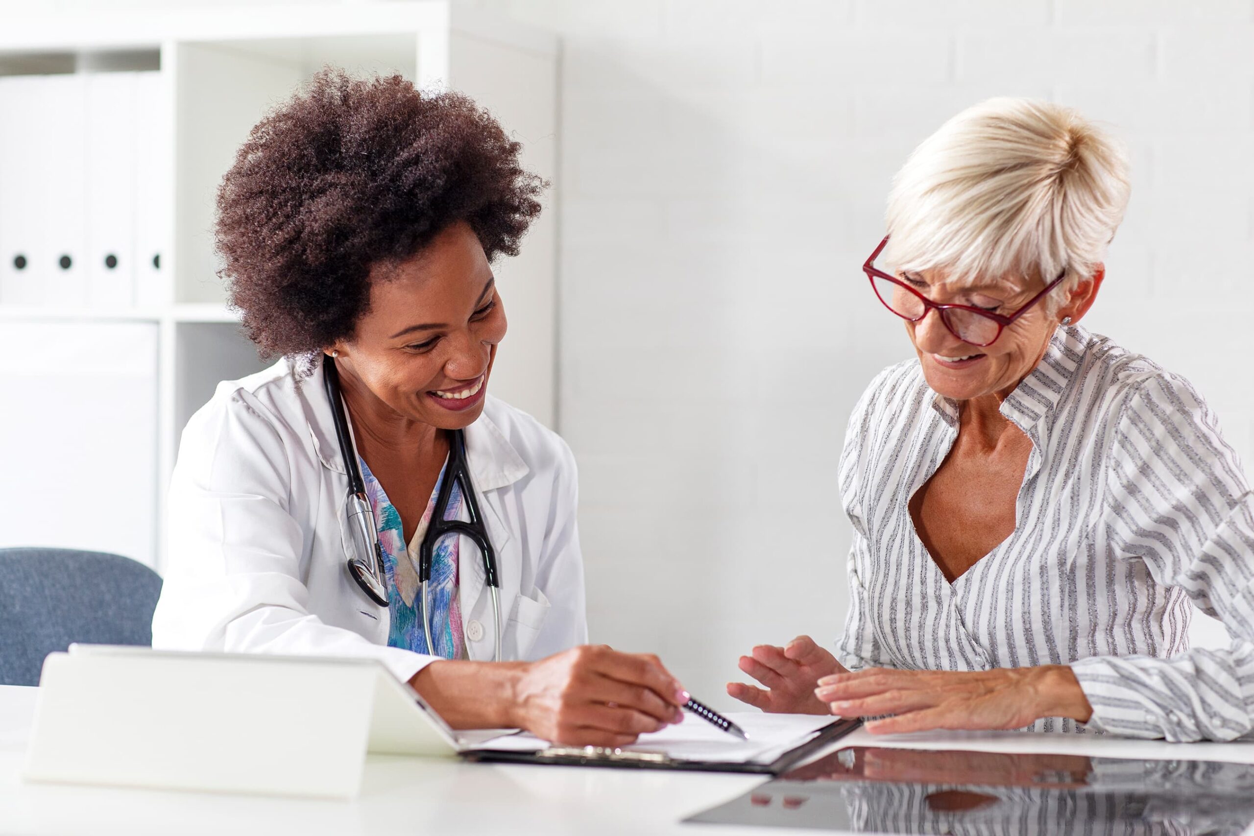 A doctor and patient looking at patient medical records